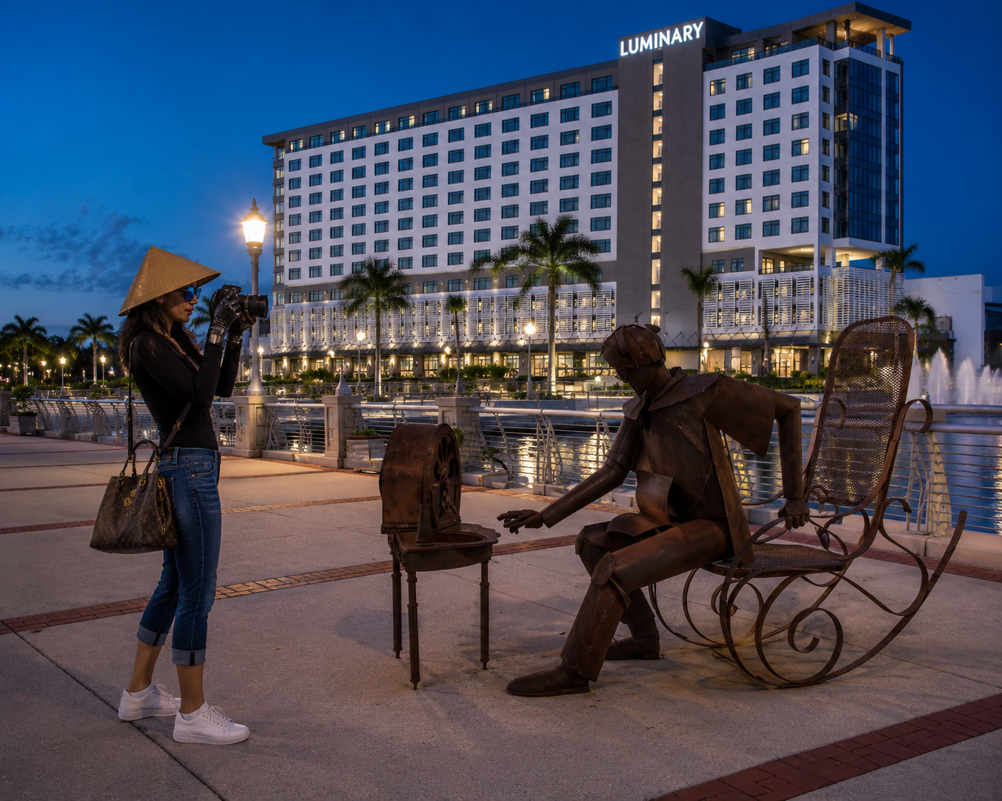 Asia: Rank Local Web Design & SEO's female Ai mascot and area guide taking pictures of the metal sculptures in front of the Luminary hotel in Downtown Fort Myers